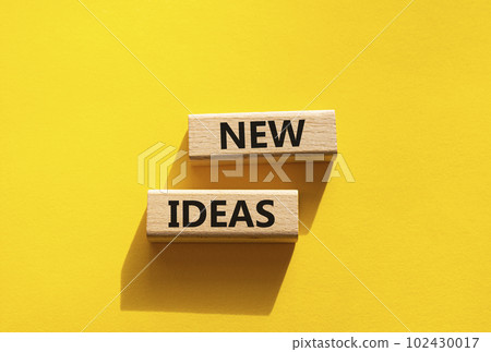 New ideas symbol. Concept word New ideas on wooden blocks. Beautiful yellow background. Business and New ideas concept. Copy space New ideas symbol. Concept word New ideas on wooden blocks. Beautiful yellow background. Business and New ideas concept. Copy space 102430017