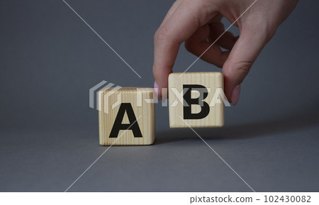 Plan A and Plan B. Businessman hand is making a choice between Plan A and Plan B symbol. Beautiful grey background. Business concept. Copy space. Plan A and Plan B. Businessman hand is making a choice between Plan A and Plan B symbol. Beautiful grey background. Business concept. Copy space. 102430082