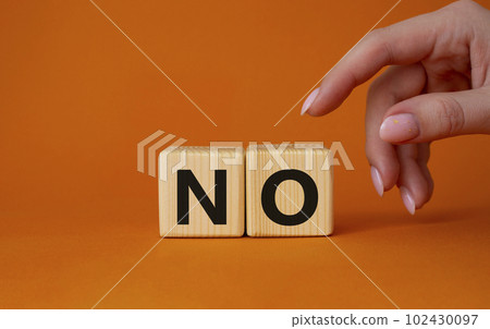 No symbol. Concept words No on wooden blocks. Businessman hand. Beautiful orange background. Business and No concept. Copy space. No symbol. Concept words No on wooden blocks. Businessman hand. Beautiful orange background. Business and No concept. Copy space. 102430097