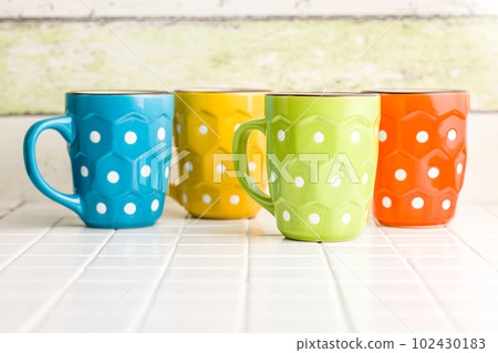 The polka dot mugs on kitchen table. The polka dot mugs on kitchen table. 102430183