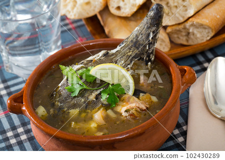 Fish soup with sturgeon in pottery 102430289