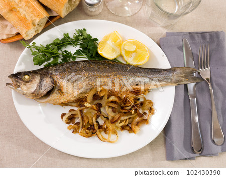 Sea bass with roasted onion 102430390