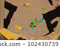 Plastic toys in the sandbox at the playground. Car, horse, saucer 102430739