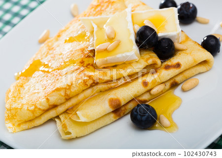 Crepes with brie and honey Crepes with brie and honey 102430743