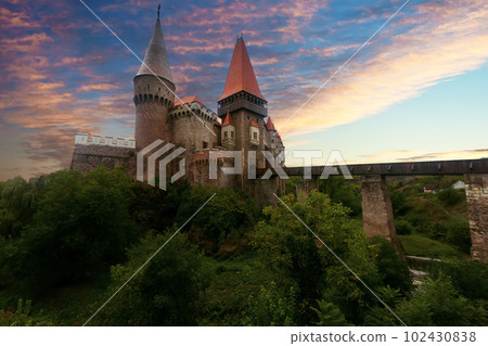 Corvin Castle in evening dusk, Romania Corvin Castle in evening dusk, Romania 102430838