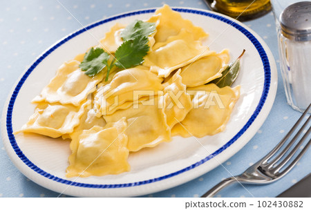 Delicious appetizing ravioli with bay leaf and black pepper 102430882