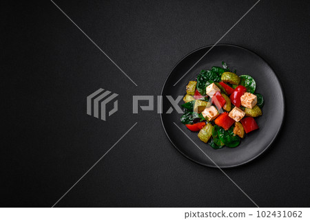 Delicious fresh salad of zucchini, cheese, sweet peppers, spinach with spices and herbs 102431062