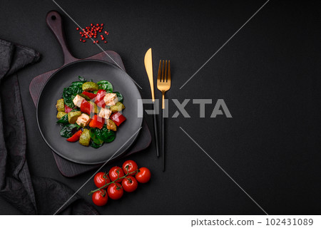 Delicious fresh salad of zucchini, cheese, sweet peppers, spinach with spices and herbs 102431089