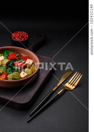 Delicious fresh salad of zucchini, cheese, sweet peppers, spinach with spices and herbs 102431140