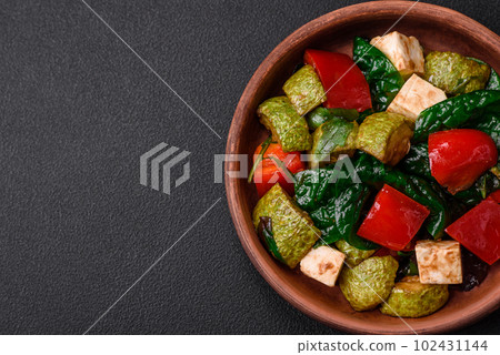 Delicious fresh salad of zucchini, cheese, sweet peppers, spinach with spices and herbs Delicious fresh salad of zucchini, cheese, sweet peppers, spinach with spices and herbs 102431144