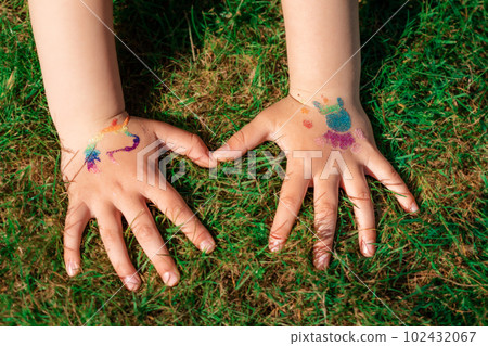 Shimmering sparkling glitter tattoo on a child's hand at a birthday party Shimmering sparkling glitter tattoo on a child's hand at a birthday party 102432067