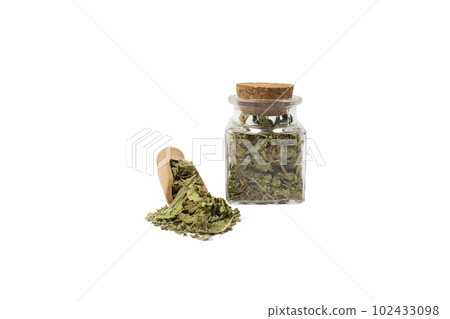 Dried leaves o Lemon verbena in latin Aloysia citrodora in wooden scoop and glass jar on isolated on white background. Medicinal herb. 102433098