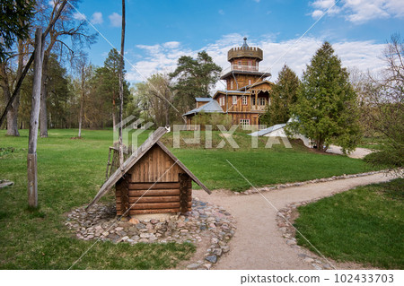 Zdravnevo, Vitebsk region, Belarus. The place near the Western Dvina River, where the painter Ilya Repin lived and rested in the summer. wooden well in the foreground. Zdravnevo, Vitebsk region, Belarus. The place near the Western Dvina River, where the painter Ilya Repin lived and rested in the summer. wooden well in the foreground. 102433703
