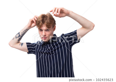 emotional positive 25 year old blond man with tattoos in a striped polo posing on a white background emotional positive 25 year old blond man with tattoos in a striped polo posing on a white background 102435623