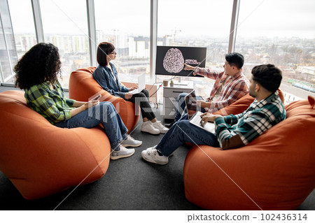 Businesspeople using devices for ML system in workspace Businesspeople using devices for ML system in workspace 102436314