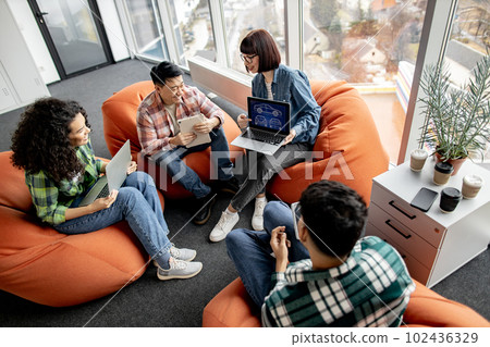 Car designers using laptop with digital model at work 102436329