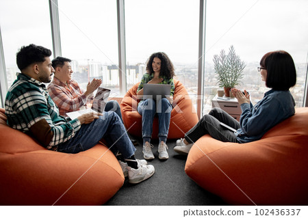 Businesswoman receiving applause from colleagues in office Businesswoman receiving applause from colleagues in office 102436337