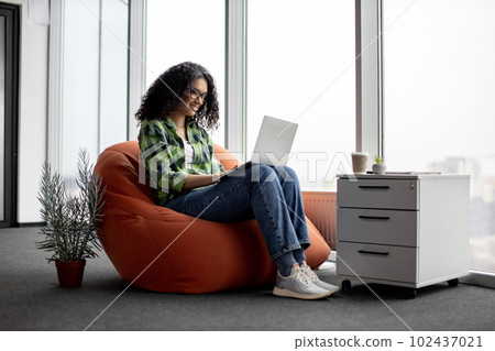 Female using computer during coffee break at work Female using computer during coffee break at work 102437021