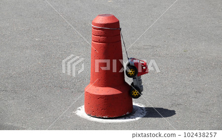 Baby car hanging on a concrete traffic limiter Baby car hanging on a concrete traffic limiter 102438257