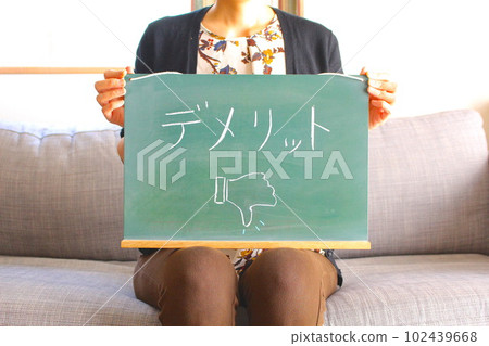Woman with demerit chalkboard letter Woman with demerit chalkboard letter 102439668