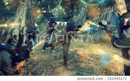 Teams facing on battlefield in outdoor paintball arena during match 102440272