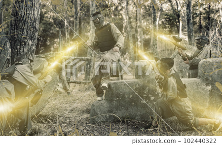 Team of paintball players attacks enemy at an army training ground Team of paintball players attacks enemy at an army training ground 102440322