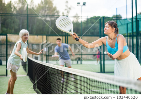 Women playing padel tennis on court 102440520
