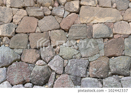 A stone wall engraved with the clan's crest 102442337