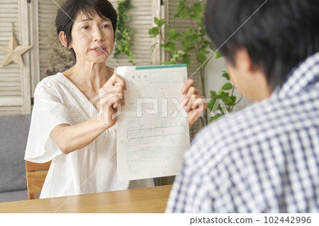 Middle-aged divorce Middle-aged woman presenting divorce papers 102442996
