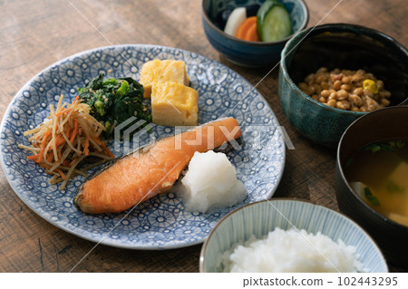 A Japanese breakfast served on a table in the morning sun 102443295