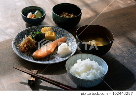 A Japanese breakfast served on a table in the morning sun 102443297