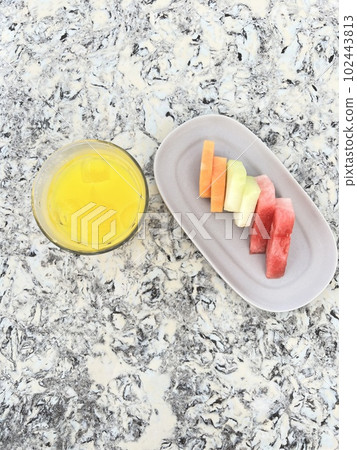Orange juice and fruit platter Orange juice and fruit platter 102443813