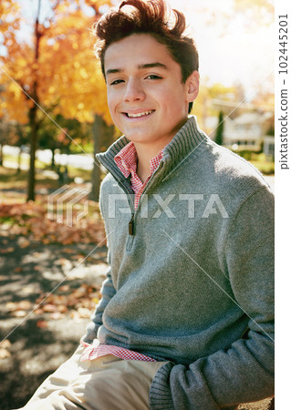 Its autumn and Im feeling chilled. Portrait of a happy teenage boy enjoying an autumn day in the park. Its autumn and Im feeling chilled. Portrait of a happy teenage boy enjoying an autumn day in the park. 102445201