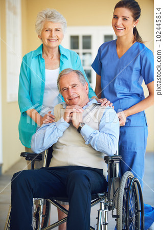 Supporting her patients through the senior years. a doctor standing with her senior patient and his wife. 102445814