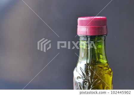 bottle of olive oil against black background bottle of olive oil against black background 102445902