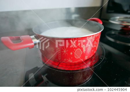 cooking pan on electric stove, electric stove is heated to red.  102445904