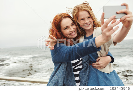 The best thing about memoriesis making them. a mother and her young daughter taking a selfie at the waterfront. 102445946