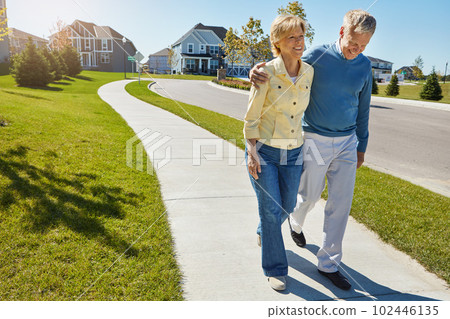 Getting a little fresh air together. a happy senior couple waking around their neighborhood together. Getting a little fresh air together. a happy senior couple waking around their neighborhood together. 102446135