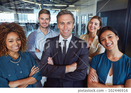 We stand together for corporate success. Portrait of a team of professionals standing together in an office. We stand together for corporate success. Portrait of a team of professionals standing together in an office. 102446916
