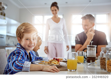 Breakfast helps me to keep active all day. a family having breakfast together. 102446920