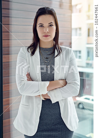 Shes got razor sharp focus. Portrait of a successful businesswoman standing in their office. 102447661
