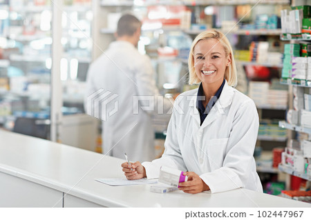I have just the remedy for you. a pharmacist at work with her colleague in the background. All products have been altered to be void of copyright infringements. 102447967