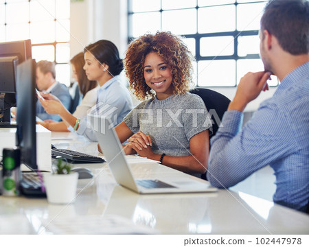 Works a breeze. Cropped portrait of a young businesswoman working in the office with her colleagues. Works a breeze. Cropped portrait of a young businesswoman working in the office with her colleagues. 102447978