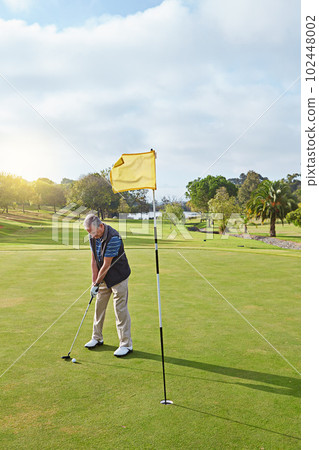 Lining up the shot. Full length shot of a senior man lining up a put while enjoying a day playing golf. Lining up the shot. Full length shot of a senior man lining up a put while enjoying a day playing golf. 102448002
