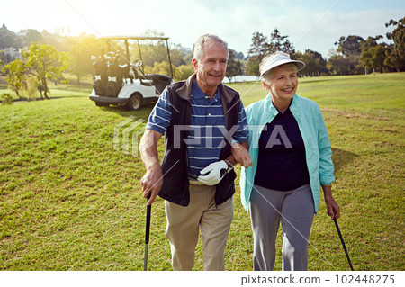Lets get going. a smiling senior couple enjoying a day on the golf course. Lets get going. a smiling senior couple enjoying a day on the golf course. 102448275