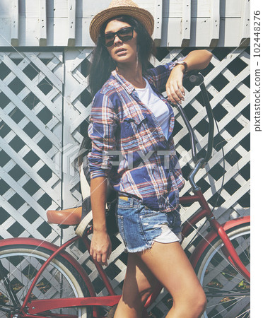 Life is a beautiful ride. a beautiful young woman riding her bike in the park. Life is a beautiful ride. a beautiful young woman riding her bike in the park. 102448276