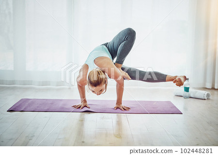 Yoga is more than just poses. an attractive woman practising her yoga routine at home. Yoga is more than just poses. an attractive woman practising her yoga routine at home. 102448281