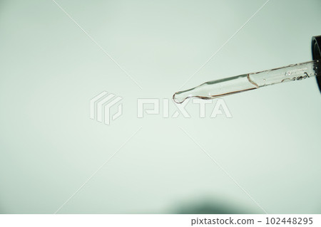 Natural medicine, cosmetic research. The concept of skin care and its analysis. Dermatology. With space to copy. Laboratory pipette with a drop of serum, oil, cosmetics. High quality photo Natural medicine, cosmetic research. The concept of skin care and its analysis. Dermatology. With space to copy. Laboratory pipette with a drop of serum, oil, cosmetics. High quality photo 102448295
