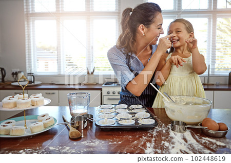Family fun in the kitchen. a mother and her daughter baking in the kitchen. 102448619