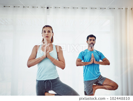 Find peace within yourself. a couple practising yoga at home. 102448810